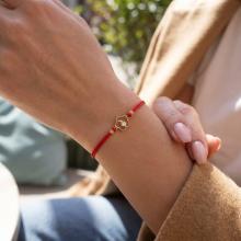 Гривна с червен конец и 14 карата златен елемент цвете с циркон