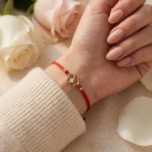 Гривна с червен конец и 14 карата златен елемент цвете с циркон