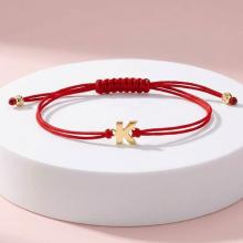 Гривна с червен конец и златни инициали