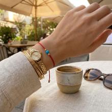 Гривна с червен конец и 14 карата златни топчета с тюркоаз Гривна с червен конец и 14 карата златни топчета с тюркоаз