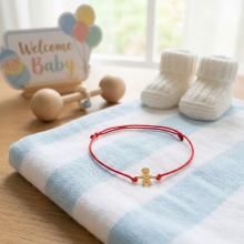 Гривна с червен конец и 14 карата златен елемент момче