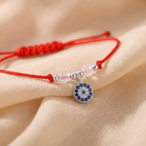 Гривна с червен конец и сребърен елемент синьо око