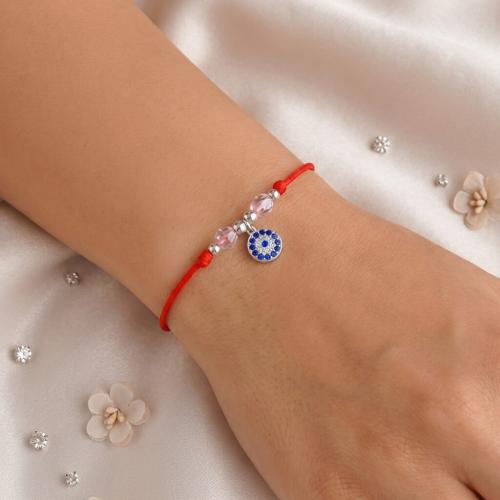 Гривна с червен конец и сребърен елемент синьо око