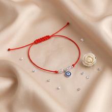 Гривна с червен конец и сребърен елемент синьо око