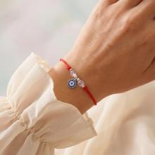 Гривна с червен конец и сребърен елемент синьо око