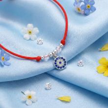 Гривна с червен конец и сребърен елемент синьо око