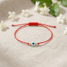 Гривна с червен конец златни топчета и синьо око