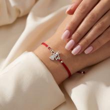 Гривна с червен конец и сребърен елемент ангелче с циркони