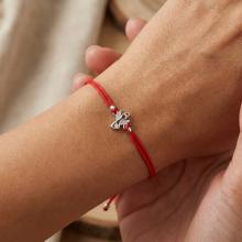 Гривна с червен конец и сребърен елемент ангелче с циркони